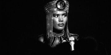 Grace Jones in portrait: Black and white shot with elaborate headpiece