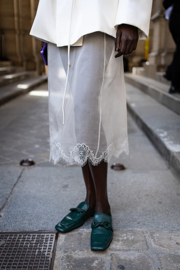 Transparent skirt with lace hem and green loafers by Carven