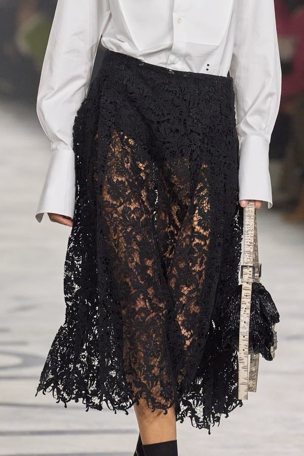 Black lace skirt with white blouse by Fendi