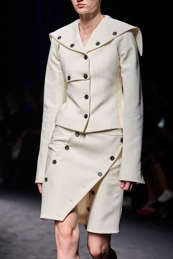 Cream-colored set with asymmetrical button skirt by Ferragamo